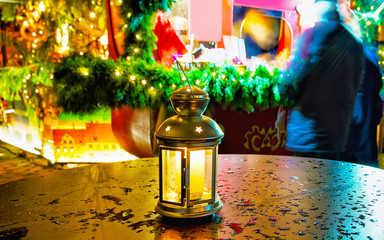 Wall Mural - Street glass lamp with candle at Christmas Market at Winter Riga, Latvia. Advent Fair Decoration and Stalls with Crafts Items on the Bazaar. Latvian street Xmas and holiday