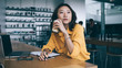 © BullRun - Asian woman drinking coffee and thinking at desk