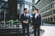 © BullRun - Multicultural male and female entrepreneurs walking around city street in downtown and communicate about upcoming startup project,diverse business people in formal suit strolling in financial district