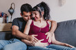 © Eva - young couple at home hugging. Happy Pregnant woman smiling