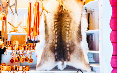 Poster - Market stall with traditional souvenirs such as reindeer skin and horns in winter Rovaniemi Finland in Lapland in winter. Street Xmas holiday fair. Advent Decoration and Stalls with Crafts on Bazaar