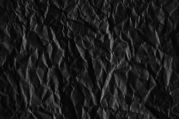 Dark black paper background creased crumpled blank posters old torn ripped surface grunge textures placard backdrop empty space for text     