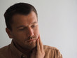 © Andrei - the man feels a toothache, checks with his hand touching the swollen cheek.