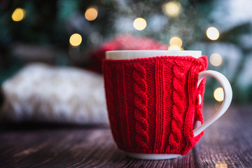 Christmas coffee or tea red mug with steam, homemade gingerbread christmas cookies on a wooden table, sweeters on background