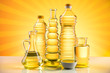 Rapeseed oil, sunflower oil, olive oil on sunburst orange background