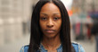 © blvdone - Young black woman in city serious face portrait