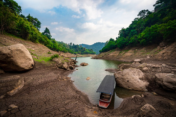 take a boat to beautiful blue sky green forest mountains lake view at Khun Dan Prakarn Chon Dam waterfall,  nakhon nayok, Thailand. an idea for backpacker hiking or camping on long weekend holiday