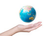 © hqrloveq - Close-up of a hand holding a globe.