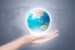 © hqrloveq - Close-up of a hand holding a globe.