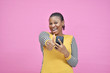 excited and happy young african lady holding her mobile phone and giving a thumbs up