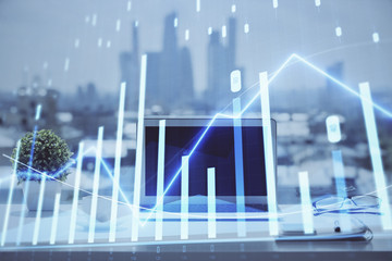 Forex graph hologram on table with computer background. Multi exposure. Concept of financial markets.