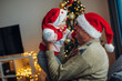 © likoper - Grandfather gives a christmas present to granddaughter