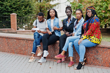  Group of five african college students spending time together on campus at university yard. Black afro friends studying. Education theme.