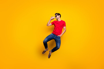 Poster - Full length photo of cheerful charismatic guy jump drink espresso take away cup enjoy free spring time wear red t-shirt sneakers isolated yellow color background