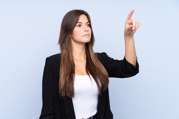 young brazilian business woman over isolated blue background touching on transparent screen