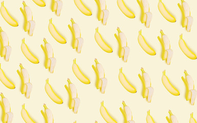 Wall Mural - Whole and open bananas on a light background. Vegetarian concept. Creative drawing, minimalism, top view, flat lay. Tasty and healthy food.