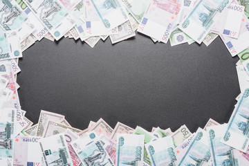 Wall Mural - top view of empty frame of dollar, euro and ruble banknotes on black background with copy space