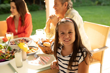 Wall Mural - Family eating outside together in summer