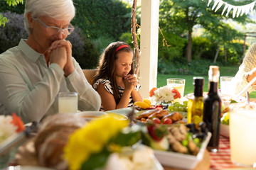 Wall Mural - Family eating outside together in summer