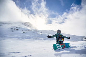 Wall Mural - Happy Snowboarder on snowy day at winter mountains .