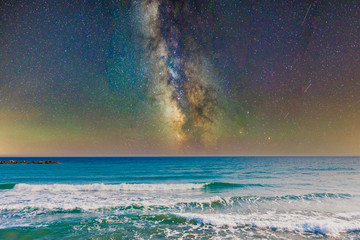Wall Mural - night sky, milky way galaxy stars and space with sea or ocean and waves at the beach.