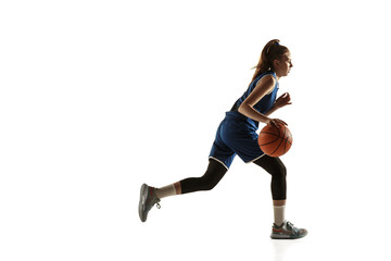 Wall Mural - Young caucasian female basketball player of team in action, motion in run isolated on white background. Concept of sport, movement, energy and dynamic, healthy lifestyle. Training, practicing.