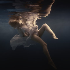 Wall Mural - Woman in a beautiful dress swims underwater