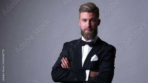 Fotografía Handsome caucasian man with beard in classic black suit.