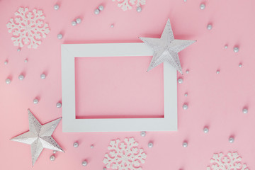 white frame on pink christmas background with silver stars and snowflakes