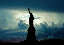 Silhouette Of Statue Of Liberty Over Dramatic Skies, New York, USA
