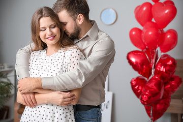 Happy young couple celebrating Valentine's Day at home