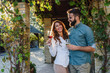 © lordn - Young smiling man and woman tasting wine at winery vineyard - Young people enjoying harvest time together
