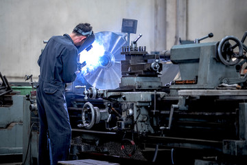 Wall Mural - Workers is milling metal parts with lathes machines with high precision in the work process, Manufacturing industrial.