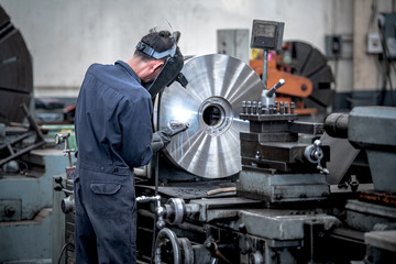 Wall Mural - Workers is milling metal parts with lathes machines with high precision in the work process, Manufacturing industrial.