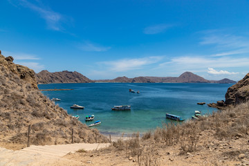 Landscape view at Padar island bay with tourists boats in Komodo islands, Flores, Indonesia.