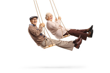 Canvas Print - Elderly man and woman swinging and laughing