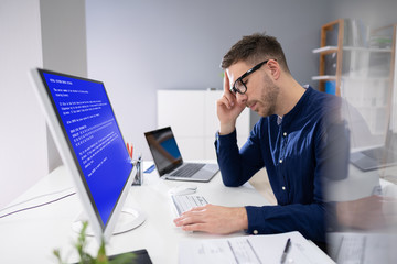 Poster - Worried Man At Computer With System Failure On The Screen