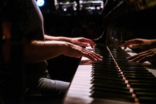 Mans Hands Playing Piano