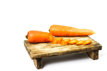 Wall Mural - carrot slices on wooden boards isolated on white background