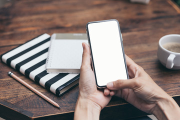 Mockup image blank white screen cell phone.men hand holding texting using mobile background empty space for advertise text.people contact marketing business and technology 