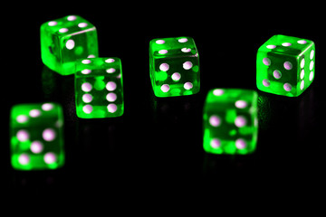 Green transparent dice on black background close-up. Gambling сoncept