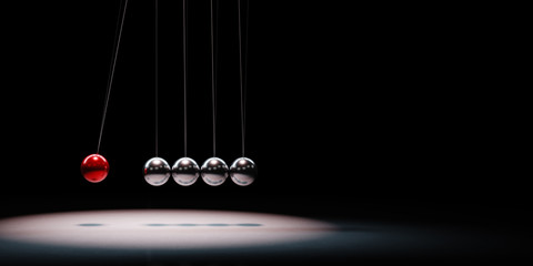 metallic balls mechanism spotlighted on black background