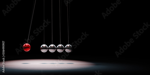 Fotografía Metallic Balls Mechanism Spotlighted on Black Background