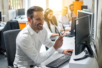 Wall Mural - Smiling businessman working in office