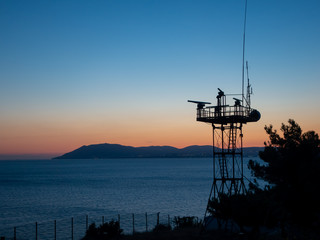  Evening sea at sunset, clear sky, radio tower in the foreground, background with copy space