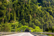 Road tunnel in Alpine mountains, Switzerland. Panoramic view of entrance of tunnel in Alps.