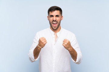 Wall Mural - Handsome man with beard over isolated blue background frustrated by a bad situation