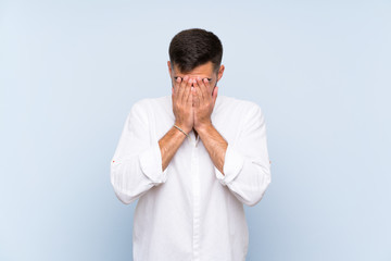 Wall Mural - Handsome man with beard over isolated blue background with tired and sick expression