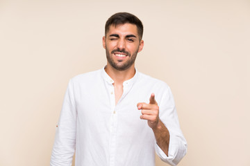 Wall Mural - Handsome man with beard over isolated background points finger at you