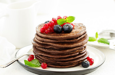 Wall Mural - Chocolate pancakes with berries.